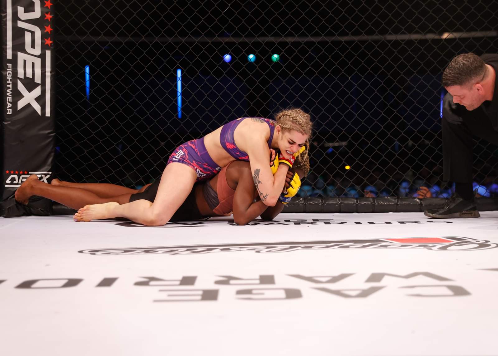 Kate Bacik controlling her opponent on the mat from behind